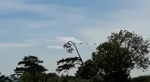 Torbay, Devon, England: The RAF Red Arrows fly in from the west towards Torbay Stock Footage 109413454