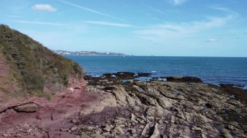 Torbay, South Devon, England: Drone View: Isolated man, rock formations and sea Stock Footage 218851724