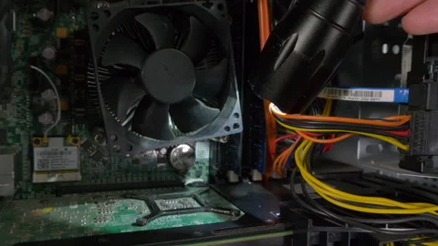 Torch being used to light up the inside of a desktop computer. Stock-Footage 161898097