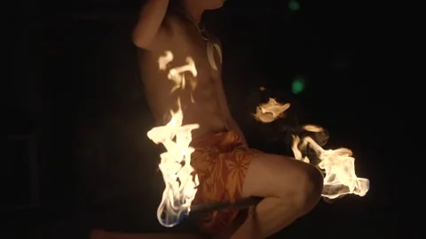 Torch between fire dancer leg Stock Footage 308044089