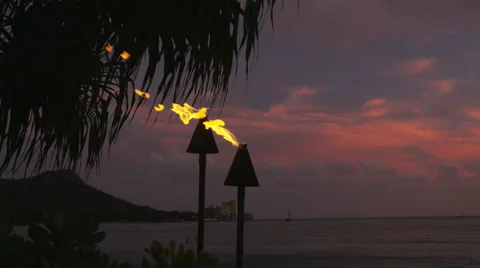 Torch fire flames burning in Hawaii sunset sky Stock Footage 55817402