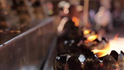 Torch Flame Illuminating a Sacred Idol in Thai Temple Ceremony Stock-Footage 333705219
