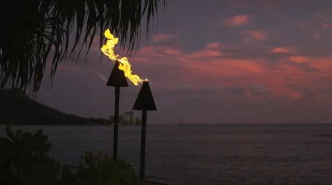 Torch lantern with fire flames burning in Hawaii sunset Stock Footage 55818015