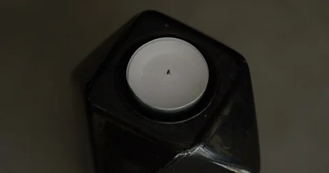 Torch lighter lighting candle in geometric candle holder Stock Footage 105509294