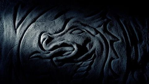 Torch Lights Up Dragon Carving On Cave Wall Stock Footage 109360989