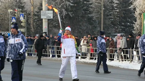 Torchbearers pass the fire. olympic torch relay in omsk. russia. Stock Footage 33313089