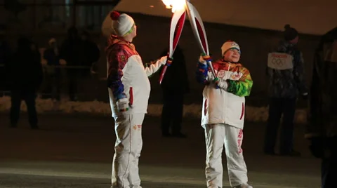 Torchbearers pass the fire. olympic torch relay in omsk. russia. Stock Footage 33313138