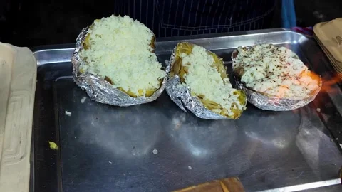 Torching Cheese on Stuffed Baked Potato at Night Market Food Stall Video stock 337421371