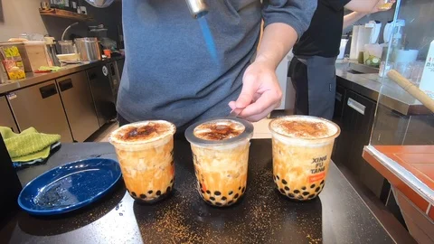 Torching sugar on bubble tea in Taiwan Stock Footage 121246821