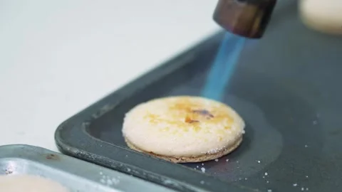 Torching Sugar on a Gourmet Macaron Dessert on a Baking Sheet Stock Footage 343019679