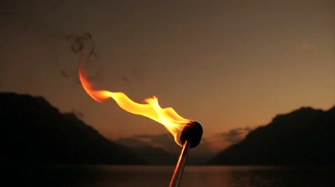 Torchlight flame burning in front of romantic twilight sky Stock Footage 42941518