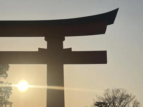 Torii gate with the background of the sun going down Stock Photos