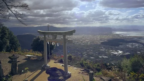 Torii Gate with sunlight changing on the top of the mountain at Takaya Shrine. Stock Footage 121308115
