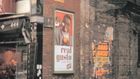 Torn ad posters plastered on old brick walls in Chicago slums depicting poverty Vidéo 237947529