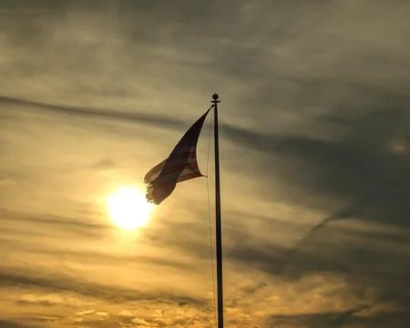 Torn American Flag at Sunset Stock Photos