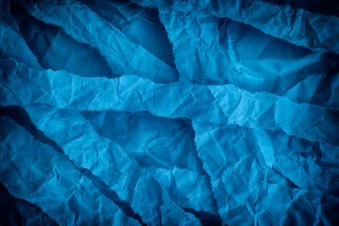 Torn and crumpled blue background Stock Photos