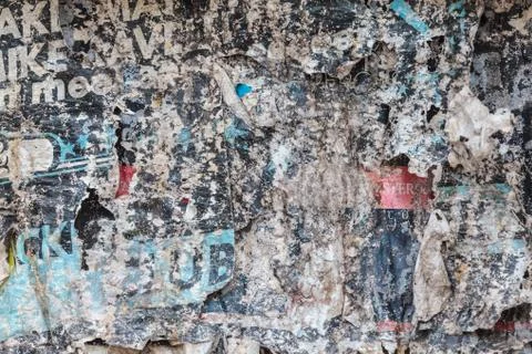 Torn and weathered advertisement posters on a wall Stock Photos