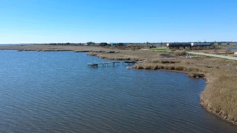 Torn up and worn boat dock dying alone deep in the bayou Stock Footage 101601711