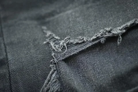 Torn black danim texture background, textile of jeans fashion for clothing .. Stock Photos