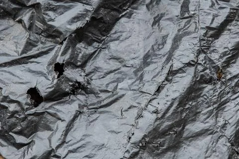 Torn Black plastic garbage bag as a background Foto stock