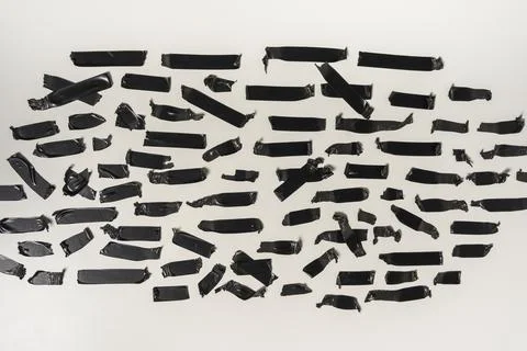 Torn black sticky tape of different sizes on a white background Stock Photos
