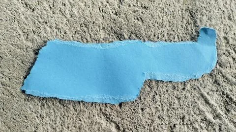 Torn Blue Paper Strip on Rough Gray Concrete Texture Background Stock Photos