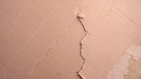 Torn brown cardboard paper with a jagged edge. Stock Footage 336548527