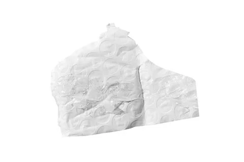 Torn bubble wrap piece with circular cells and creases isolated on white. Stock Photos