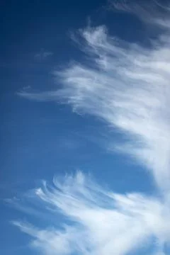 Of torn clouds in a blue sky Stock Photos