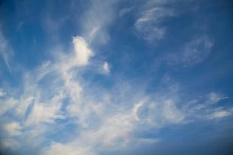 Torn clouds on a blue sky Stock Photos