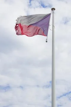 The torn Czech flag flutters in the wind. Stock Photos