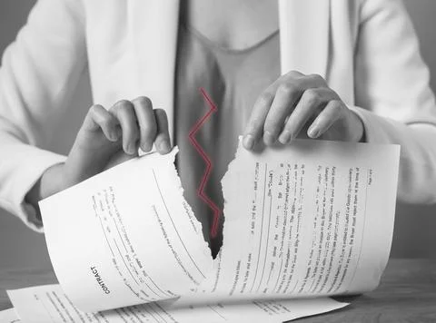 Torn document in hands. Breaking contract. Sanctions, agreement conditions and Stock Photos