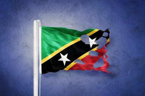 Torn flag of Saint Kitts and Nevis flying against grunge background Stock Illustration