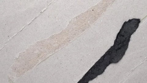 Torn grey cardboard texture with glued black paper scrap. Stock Footage 334872762