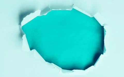 A torn hole the paper on a blue background for your advertising Stock Photos