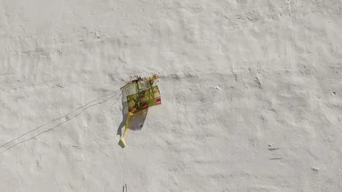 “Torn kite stuck on wall symbolizing failure and lost freedom” Stock Photos