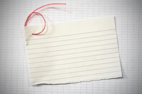 Torn lined paper with red wire in shape of number six over data paper sheet Stock Photos