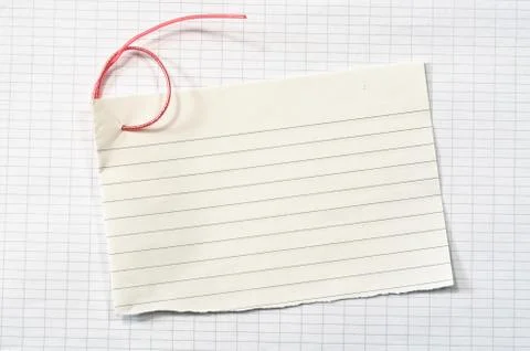 Torn lined paper with red wire in shape of number six over data paper sheet Stock Photos