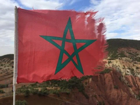 Torn Moroccan flag waving in wind Stock Photos