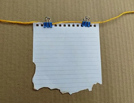 Torn note paper hanging with clothespin and string. Space for text 스톡 사진