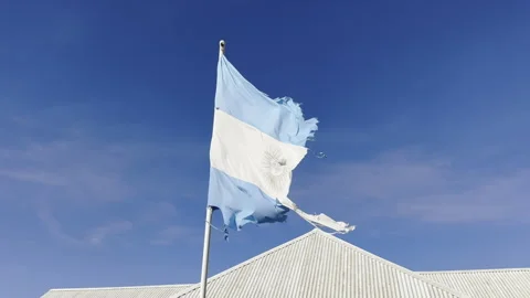 Torn or Ripped Argentina Flag Flutters Against Blue Sky. Economy Crisis LATAM Stock Footage 289556429