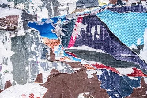 Torn paper collage background on an old poster on a street wall. Texture and Stock Photos