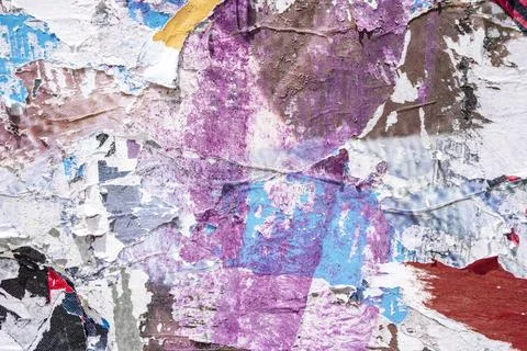 Torn paper collage background on an old poster on a street wall. Texture and Stock Photos