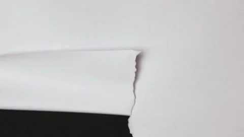 Torn paper place for your content. White torn paper on black background. Tear Stock Footage 247209588