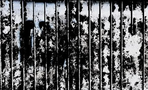 Torn Paper Scraps on Ribbed Electrical Box Isolated on Black, Grunge Texture 库存照片
