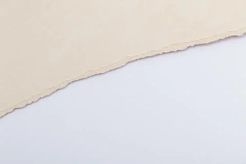 Torn paper showing a layer of beige and white as background with soft textu.. Stock Photos