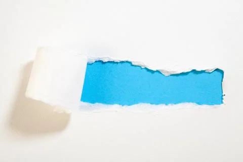 Torn paper with space for your message on a blue background. Stock Photos