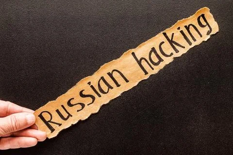 Torn paper with text RUSSIAN HACKING Foto stock