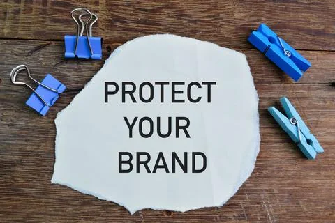 Torn paper written with text PROTECT YOUR BRAND Stock Photos