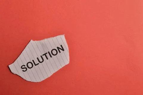 Torn paper written with text SOLUTION isolated on red background Stock Photos